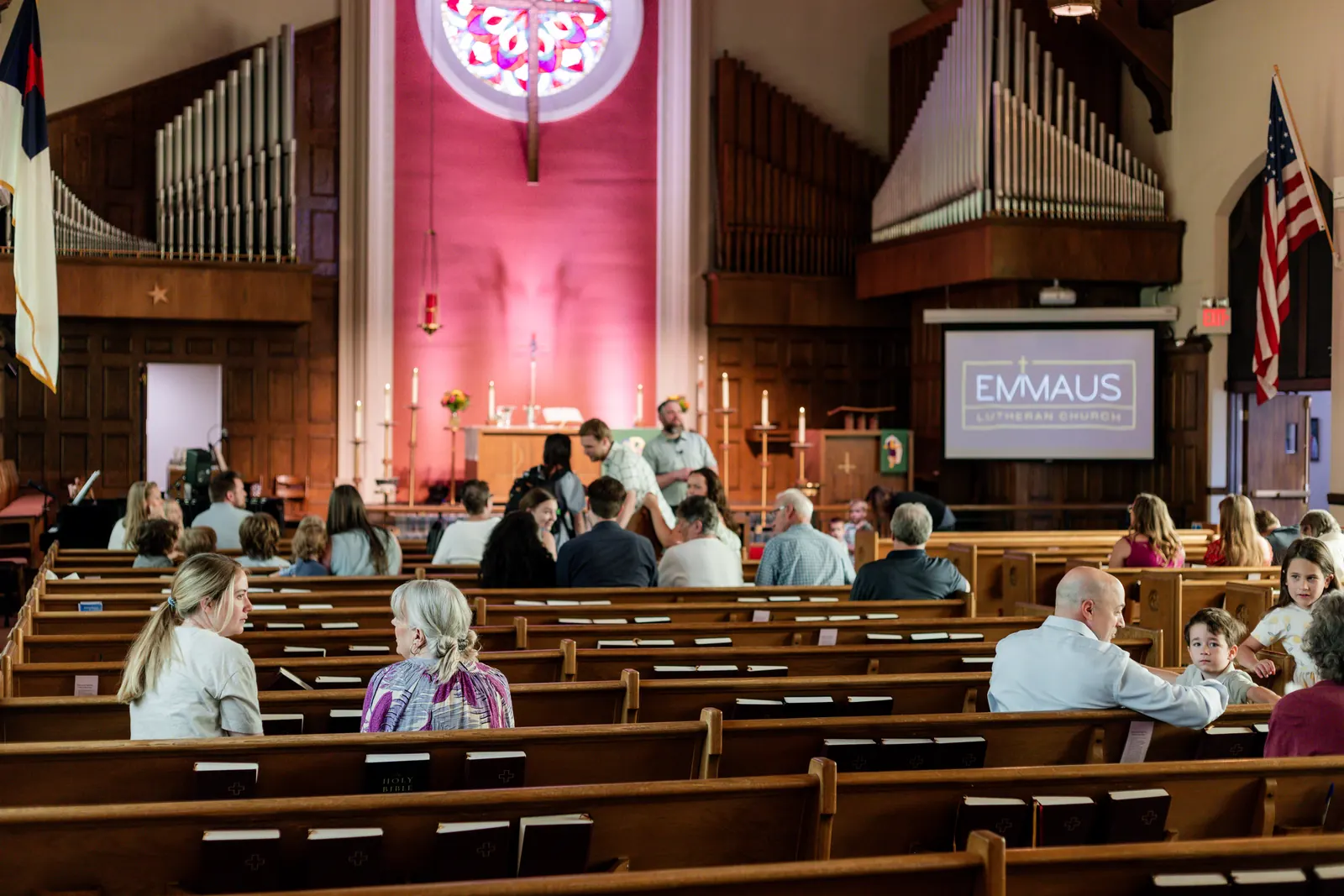 Sunday at Emmaus — the sanctuary, pews, and congregation before worship
